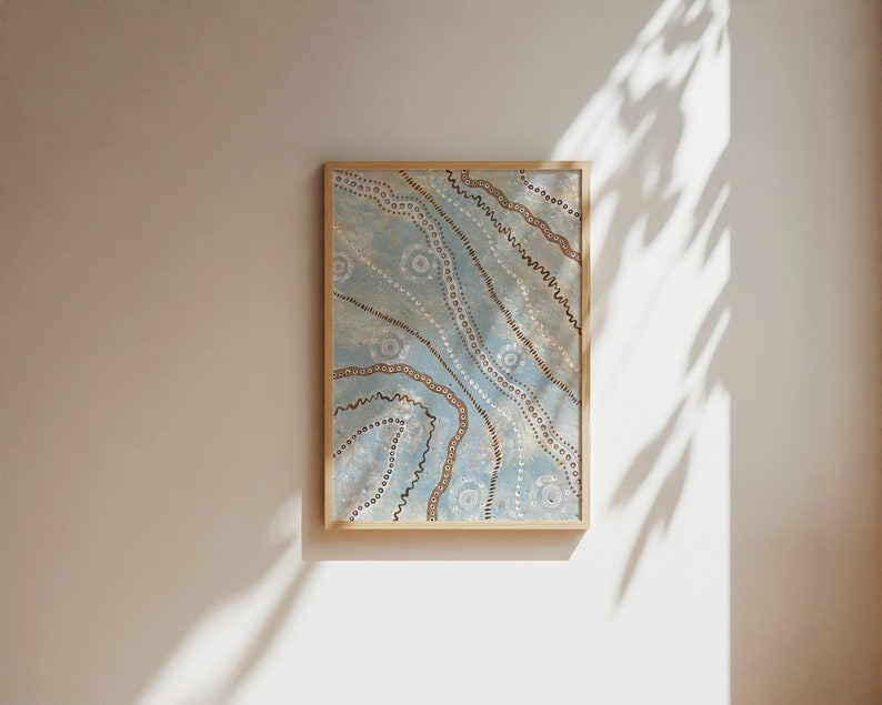 May include: A framed artwork with a blue background and brown and white patterns. The artwork features a series of wavy lines and dots.
