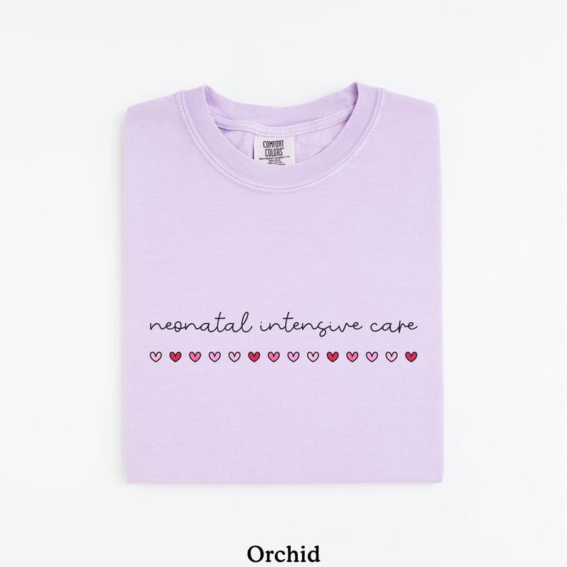 May include: A lavender colored t-shirt with the text "neonatal intensive care" and a row of small pink and red hearts.