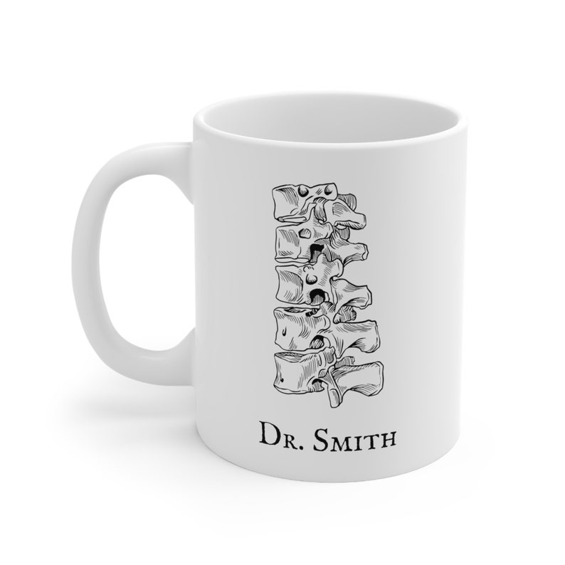 May include: White ceramic mug with a black line drawing of a human spine and the text "Dr. Smith" at the bottom.