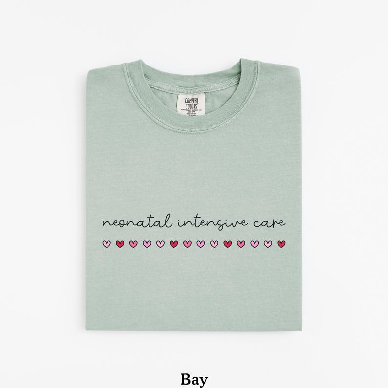 May include: A light green t-shirt with the text "neonatal intensive care" and a row of pink and red hearts.