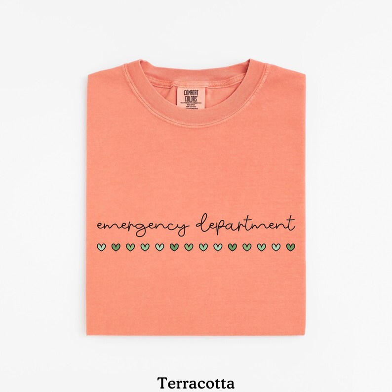 May include: Terracotta colored t-shirt with the text "emergency department" and a row of green hearts.