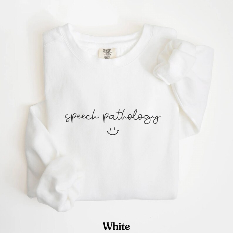 May include: White sweatshirt with the text "speech pathology" and a smiley face.
