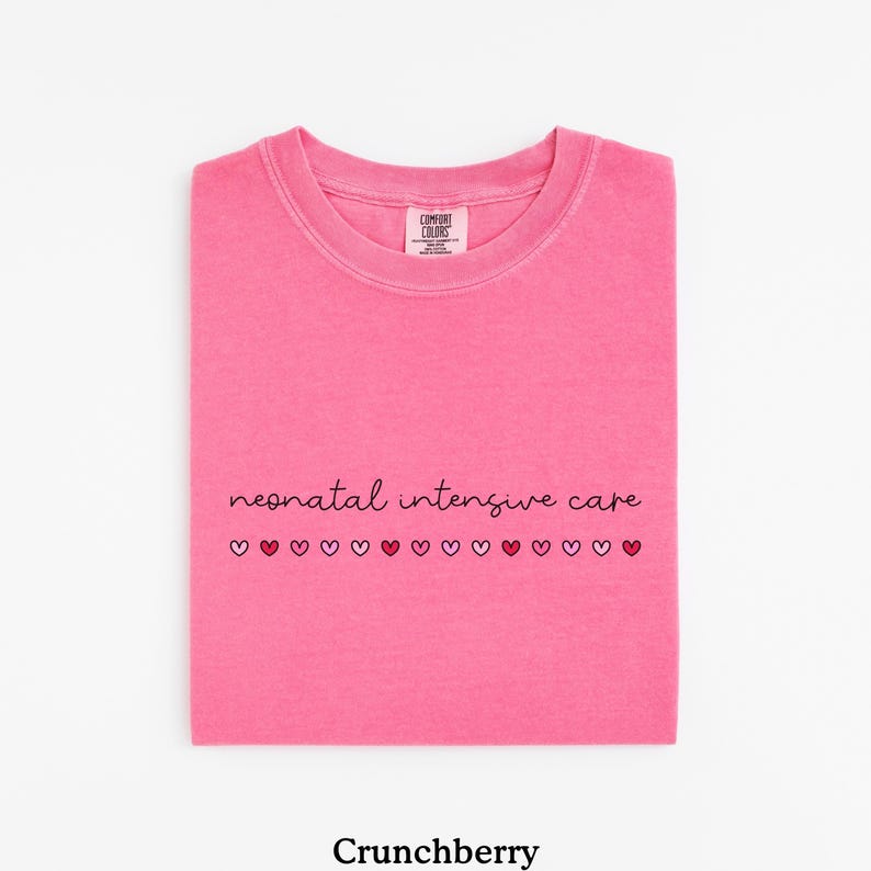 May include: Pink t-shirt with the text "neonatal intensive care" and a row of small hearts in different shades of pink and red.