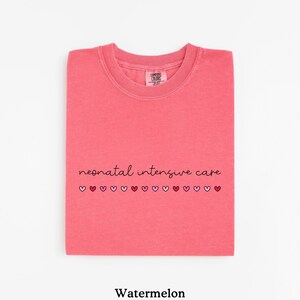 May include: Watermelon pink t-shirt with the text "neonatal intensive care" and a row of small pink and red hearts.