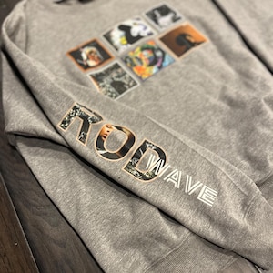 May include: Gray sweatshirt with a collage of images on the front and the text "Rod Wave" on the sleeve.