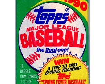 May include: A green, yellow, and red 1990 Topps Major League Baseball trading card pack. The pack features a baseball with the words "the Real one!" and a promotion for a trip to 1991 Spring Training. The pack contains 16 bubble gum cards, 1 stick bubble gum, and an entry form for the "Spring Fever Baseball" contest.