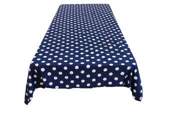 May include: A navy blue tablecloth with white polka dots. The tablecloth is rectangular and has a smooth texture.