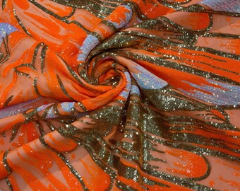 Diseño de lentejuelas de plumas iridiscentes en color naranja neón/dorado/aguamarina sobre una tela de malla elástica en 4 direcciones de color naranja. Se vende cortada a medida.