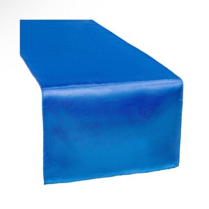 May include: A royal blue satin table runner. The runner is a solid color and has a smooth, silky texture.