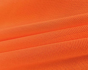 Tejido de malla elástica sólida de nailon y licra, color naranja, de 58/60" de ancho. Se vende cortado a medida.