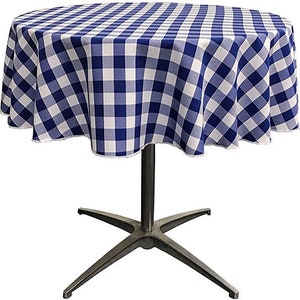 May include: A blue and white checkered tablecloth with a scalloped edge, draped over a round table with a silver base.