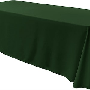 May include: A dark green rectangular tablecloth. The tablecloth is made of a smooth, wrinkle-resistant fabric.