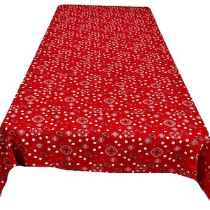 May include: Red tablecloth with a white bandana print.