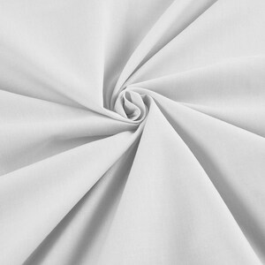 May include: White fabric with a smooth texture, folded and arranged in a spiral pattern.