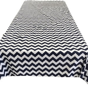 May include: A white and navy blue chevron patterned tablecloth. The tablecloth is made of a smooth, wrinkle-resistant fabric.