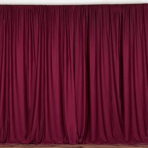 May include: A deep burgundy backdrop made of fabric with pleats. The backdrop is smooth and wrinkle-free.