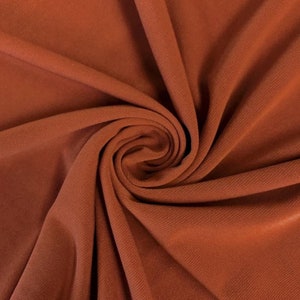 ITY Fabric Polyester Knit Jersey 2 Way Stretch Spandex Sold By The Yard. Rust