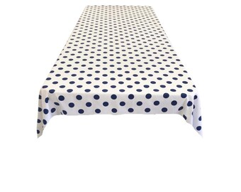 May include: White tablecloth with a navy blue polka dot pattern.