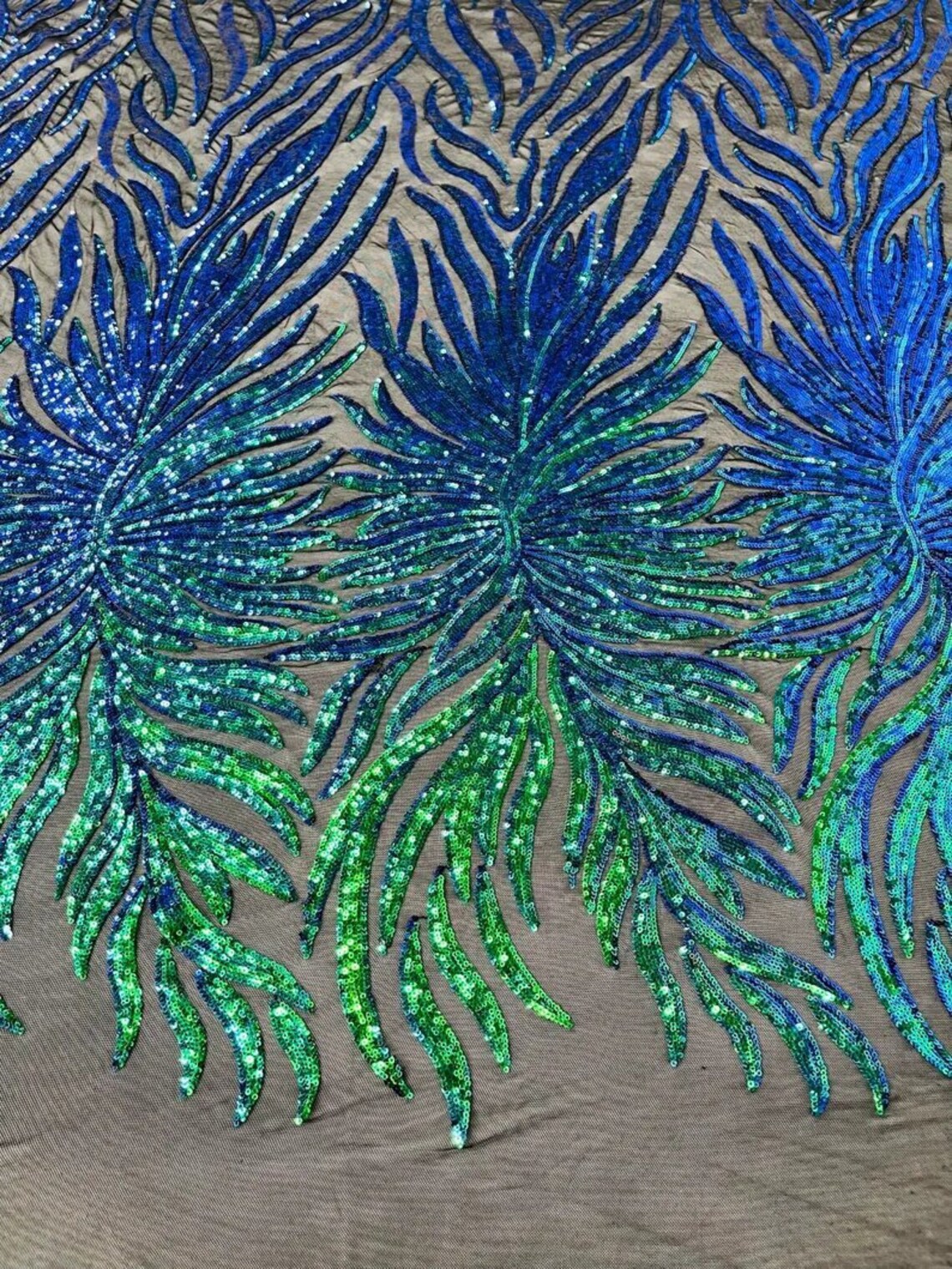 Green iridescent phoenix feather design with sequins embroider on a Black 4 way stretch mesh fabric-sold by the yard. main image 0