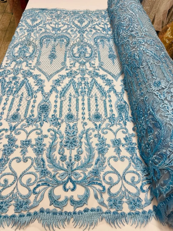 Diva Design Embroidery with Heavy Beaded On a Mesh Lace-Sold By The Yard. Light Blue