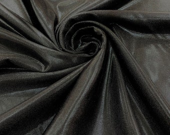 May include: Black satin fabric with a smooth, shiny finish. The fabric is draped and folded, showcasing its texture and drape.