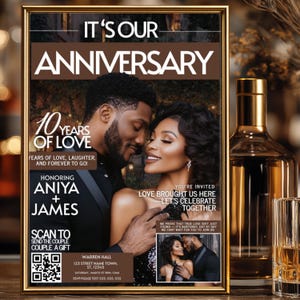 May include: A framed anniversary invitation with a gold border. The invitation features a photo of a couple, the text "It's Our Anniversary," and details for the event. A bottle of liquor and a glass are in the background.