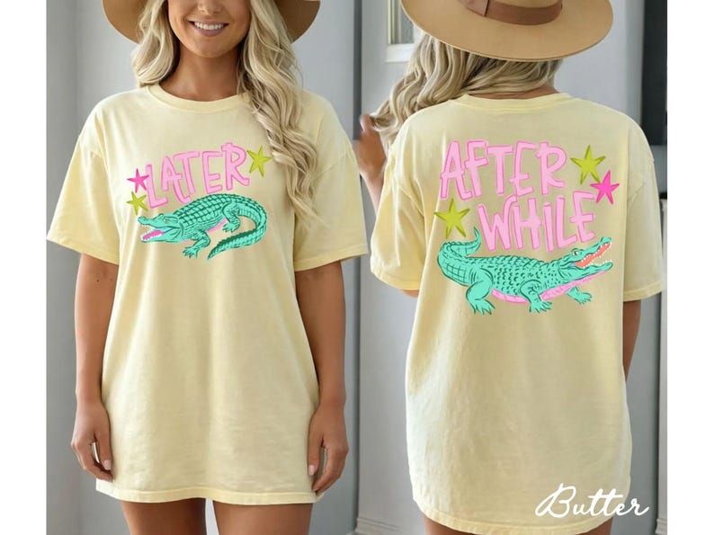 May include: Butter yellow t-shirt with a front graphic of a teal alligator and the word "LATER" in pink. The back of the shirt features the words "AFTER WHILE" and a matching alligator design. The shirt has a relaxed fit.
