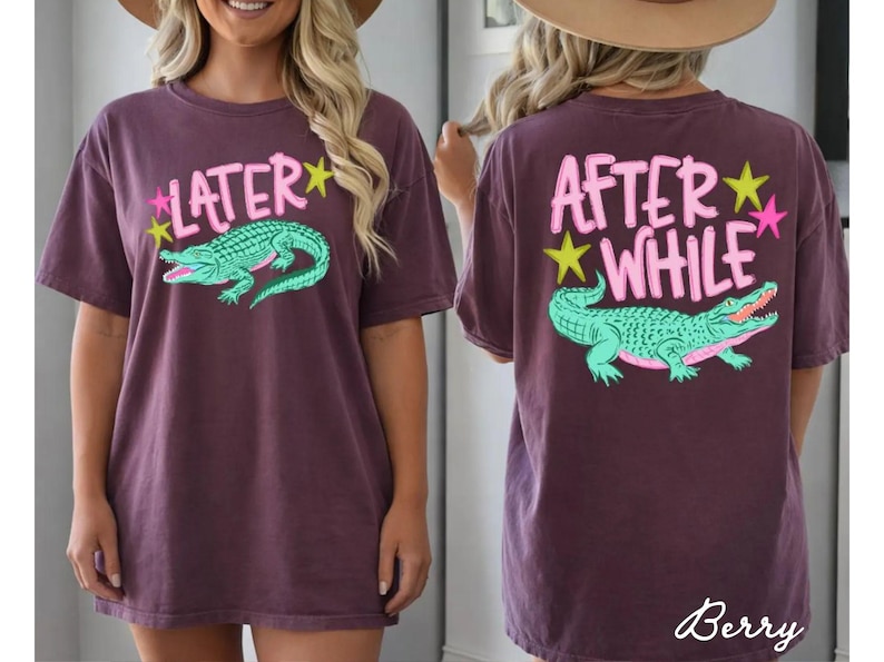 May include: Berry-colored t-shirt with a front graphic that says "Later" above a green alligator. The back of the shirt says "After While" above a matching alligator. Pink and yellow stars accent the text.