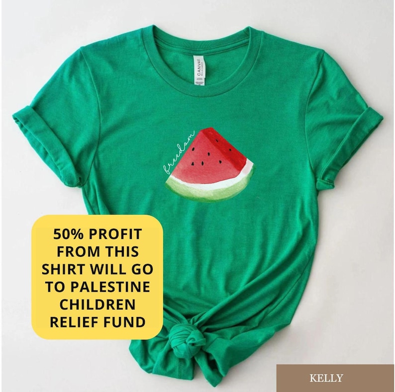 May include: A green t-shirt with a watermelon slice graphic and the word "freedom". The shirt has rolled-up sleeves and a knot at the bottom. A yellow square with text states that 50% of the profit will go to the Palestine Children Relief Fund.