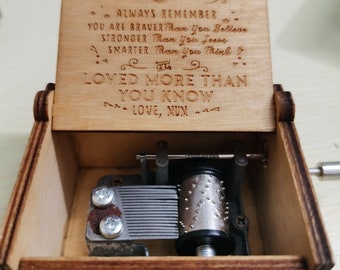 May include: Wooden music box with a carved design on the lid. The lid is open and reveals a message inside that reads "To my Son Always remember... You are braver than you believe, stronger than you seem, smarter than you think. And Loved more than you know. Love, Mum".