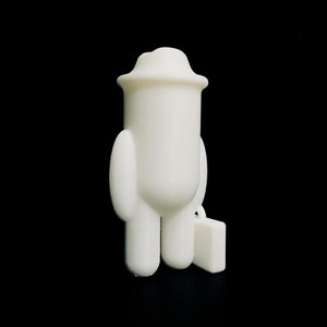 May include: A white figurine of a person wearing a hat and carrying a small suitcase. The figure has a rounded body, arms, and legs. The background is solid black.