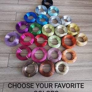 May include: A collection of colorful spools of wire in various shades, including blue, green, pink, and gold. The image features the text "CHOOSE YOUR FAVORITE COLORS" at the bottom, suggesting a selection of craft supplies.