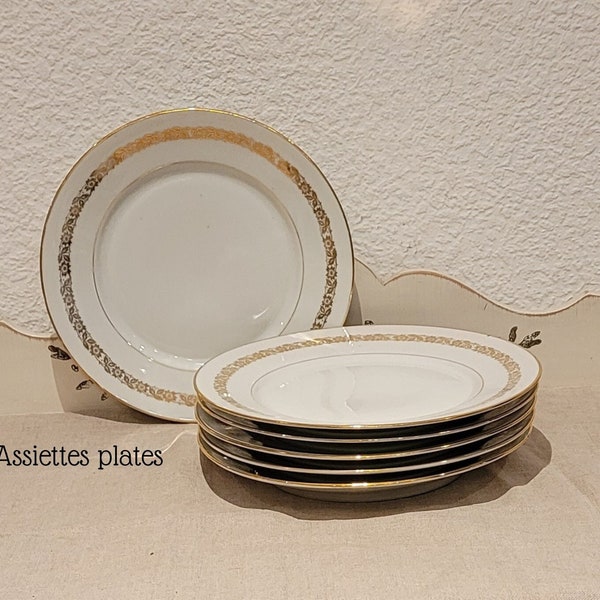 Service très chic de 6 assiettes plates et 6 assiettes à dessert en porcelaine blanche. Assiettes élégantes avec frise dorée sur le marli.