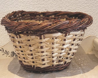 Large vintage wicker basket. Handmade braided two-tone basket. Old toy basket.