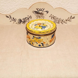 Round vintage metal toffee box. Old tin advertising box.