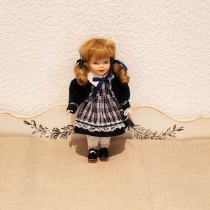 Small vintage porcelain collectible doll. Blonde vintage doll with pigtails