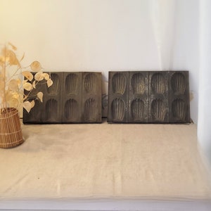 May include: Two vintage metal baking molds with a shell design. Each mold has six individual shell-shaped cavities.