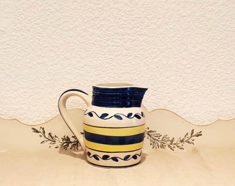 Vintage ceramic jug. Pitcher with Provencal decor. Blue and yellow carafe