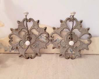 Set of 2 cast aluminum wall hooks, ornate scrollwork, porcelain knobs