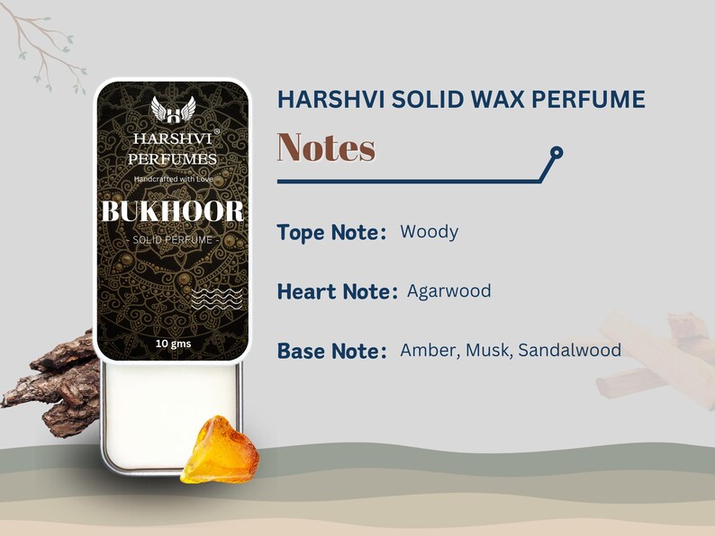 May include: A small, round, white container with a gold lid. The container is labeled "HARSHVI PERFUMES BUKHOOR SOLID PERFUME" and "10 gms". The container is sitting on a wooden surface. The text "HARSHVI SOLID WAX PERFUME" is written in black above the container. The text "Notes" is written in black below the container. The text "Tope Note: Woody" is written in black below the text "Notes". The text "Heart Note: Agarwood" is written in black below the text "Tope Note: Woody". The text "Base Note: Amber, Musk, Sandalwood" is written in black below the text "Heart Note: Agarwood".