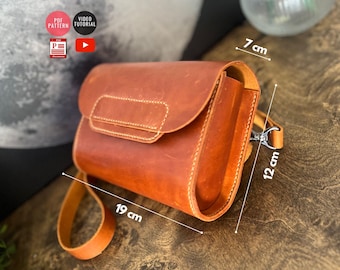 May include: A brown leather crossbody bag with a flap closure and a silver clasp. The bag measures 7 inches wide, 12 inches tall, and 19 inches long.