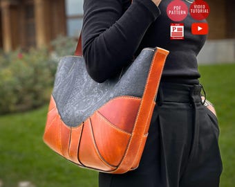May include: A handcrafted leather tote bag with a gray paisley pattern, complemented by orange and brown leather panels. The bag features a long shoulder strap and visible stitching. The image also includes text that says "PDF PATTERN" and "VIDEO TUTORIAL".