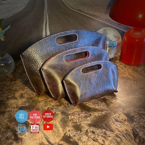 May include: Three nested dark brown textured leather-like pouches with integrated handles and visible stitching. The set includes icons for DXF file, PDF pattern, and video tutorial, indicating digital resources for crafting these items.