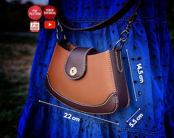 May include: A brown leather handbag with a flap closure and a brown strap. The bag measures 22 inches wide, 14.5 inches tall, and 5.5 inches deep.