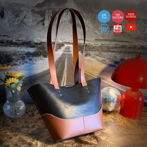 May include: A two-toned tote bag featuring a black upper section and a brown lower base with matching brown shoulder straps. The bag includes silver-toned metal rivets and white stitching. Icons indicate the availability of a DXF file, PDF pattern, and video tutorial.