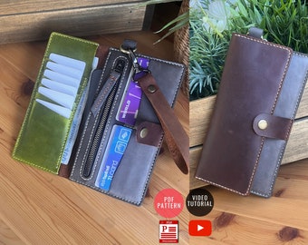 May include: Two leather wallets in shades of green, gray, and brown. One is open, revealing card slots, a zippered compartment, and currency. The other is closed with a snap closure. Both have white stitching.