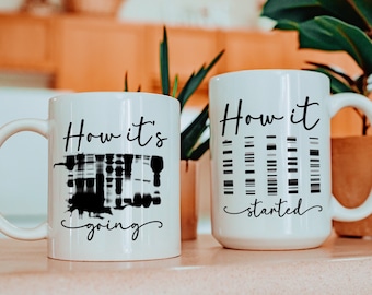 May include: Two white ceramic mugs with black text and graphic designs. The mug on the left says "How it's going" with a black and white graphic of a DNA strand. The mug on the right says "How it started" with a black and white graphic of a DNA strand.