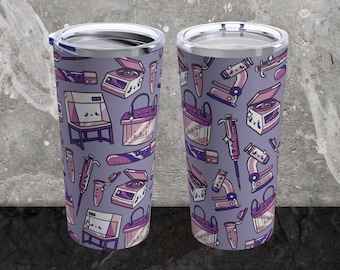 May include: Two stainless steel tumblers with a purple background and a pattern of science lab equipment, including beakers, test tubes, microscopes, and pipettes.