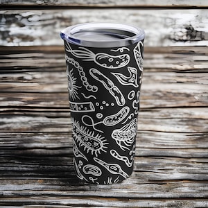 May include: A black stainless steel tumbler with a white design of various types of bacteria and microorganisms. The tumbler has a clear lid.