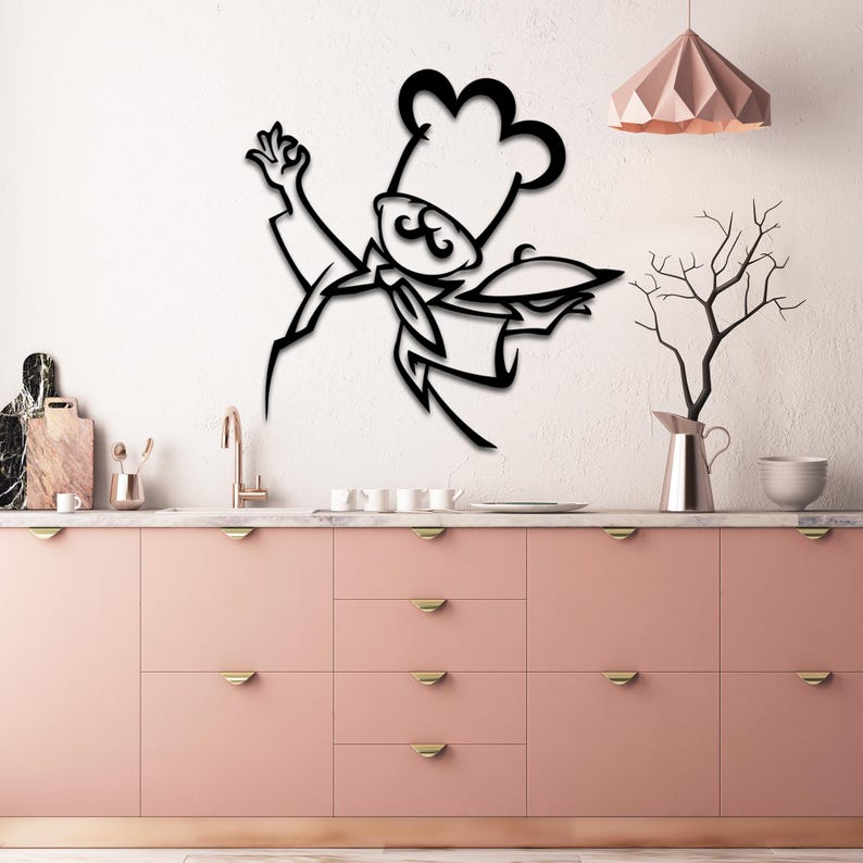 May include: Black metal wall art depicting a stylized chef in a chef's hat, playfully raising one hand. The chef is holding a platter in the other hand. The design is minimalist and modern, suitable for kitchen decor. The artwork is mounted on a pink kitchen cabinet wall above a countertop with kitchen utensils and appliances.
Kitchen Metal Wall Art, Kitchen Wall Decor, Kitchen Signs, Chef Wall Art, Restaurant Metal Wall Decor, Cafe Metal Signs, Home Kitchen Gifts